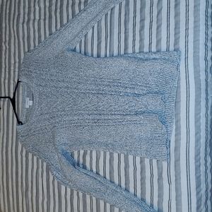 Grey knit sweater with light color speckles.